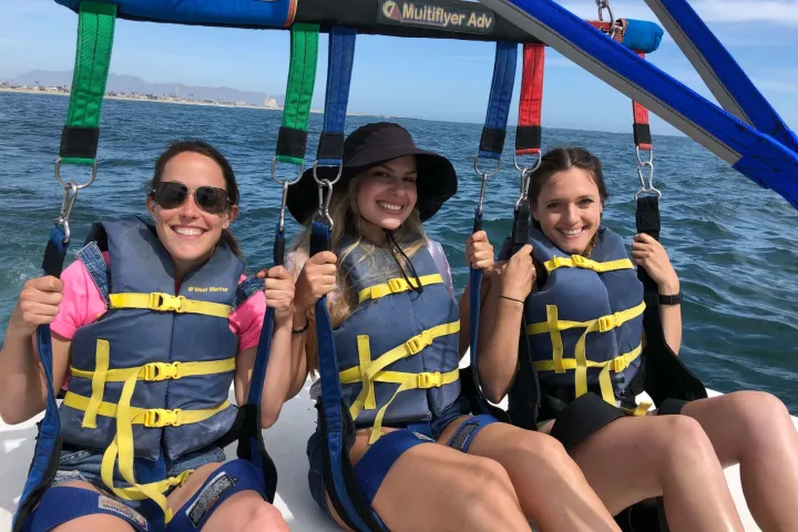 a group of people sitting on a boat in the water