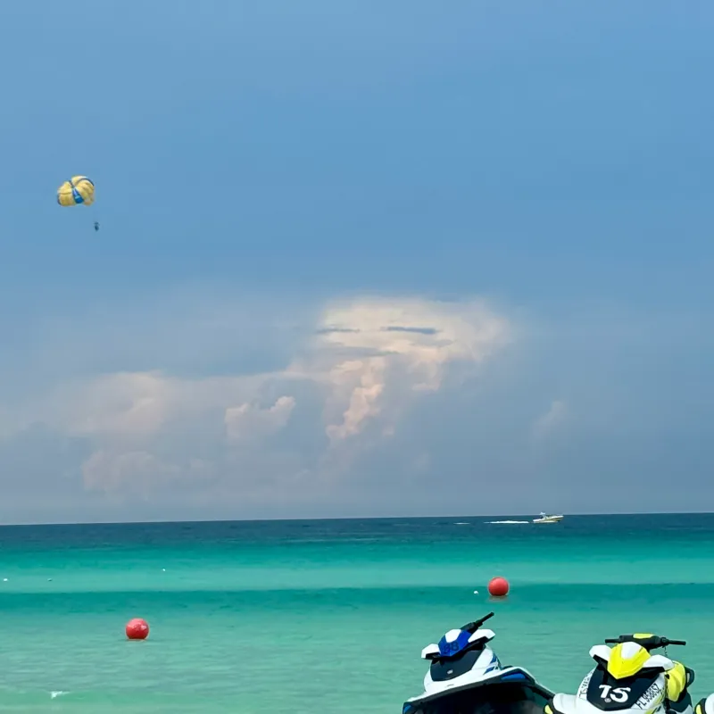 a group of people flying kites on a boat in the water